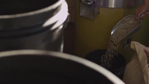 Man pour scoop of ingredients into bucket