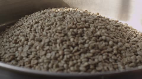 Coffee beans being poured into a bin