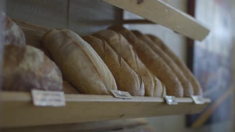 Bread is lined up on a shelf