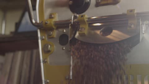 Works lifts handle up to open latch to release coffee beans