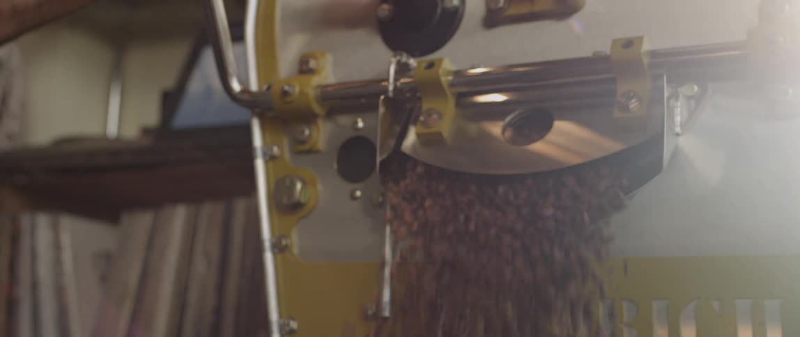 Works lifts handle up to open latch to release coffee beans