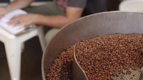 Machinery mixes a batch of beans