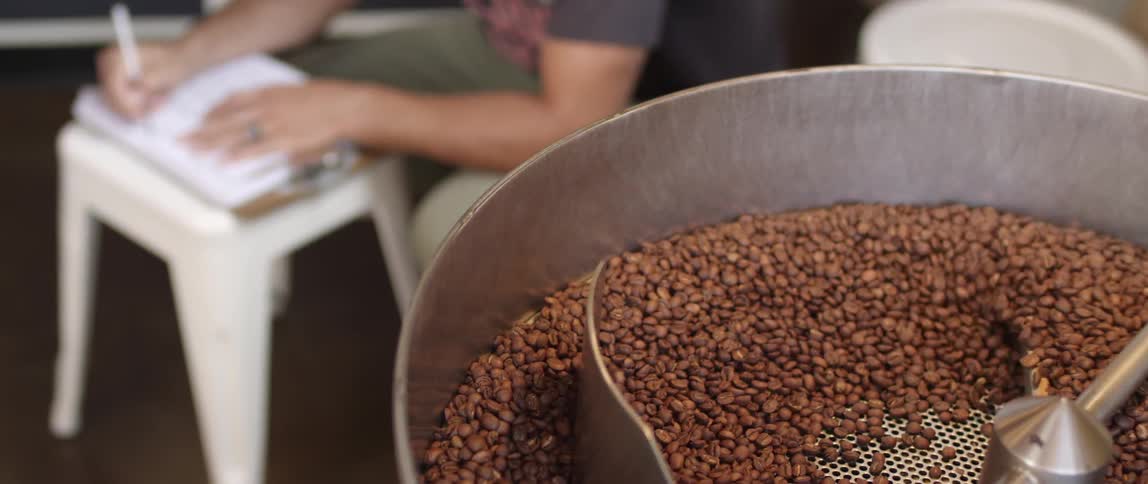 Machinery mixes a batch of beans