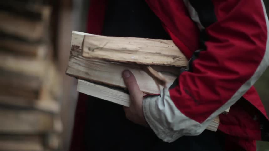 A person collecting pieces of wood