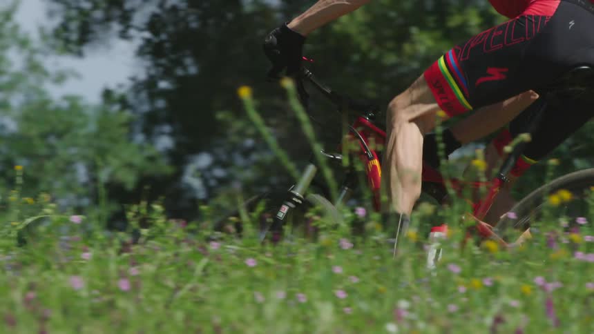 Man rides bike through a flowery field