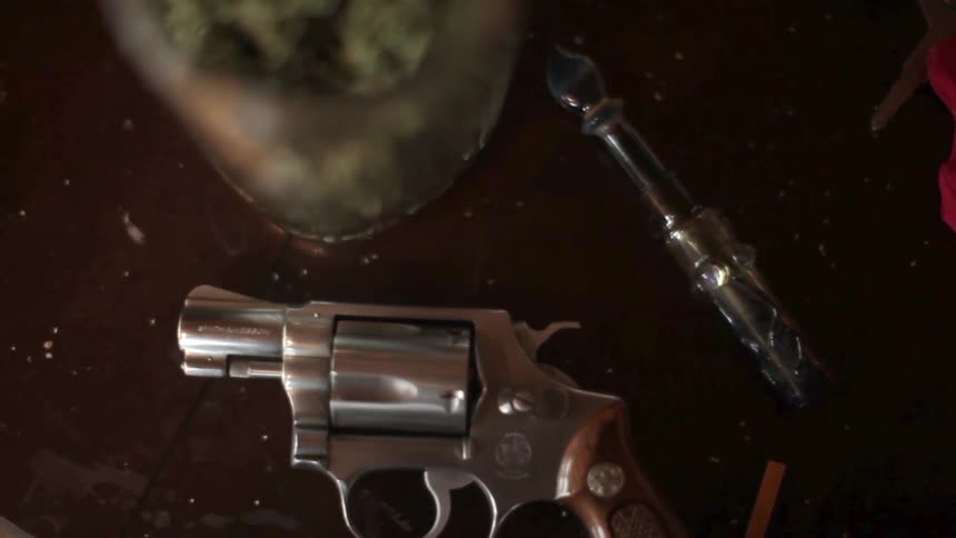 A gun on a cluttered table