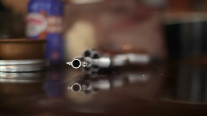 A handgun sits on a table