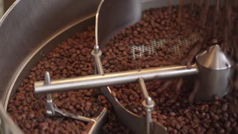 A large amount of coffee beans poured into an empty machine