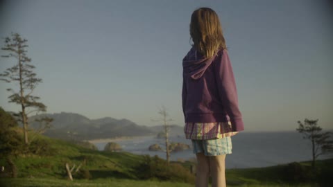A girl looks out over the ocean