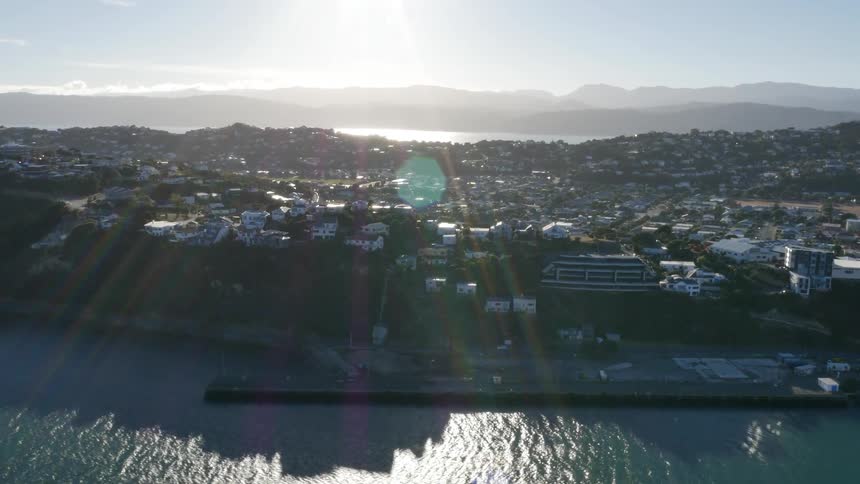 Aerial view of a city in front of a body of water