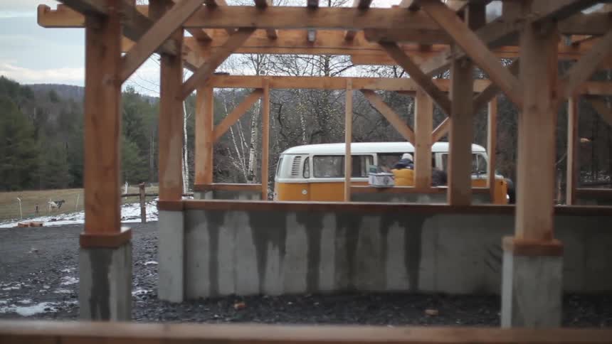 Man outside a vw bus next to a building