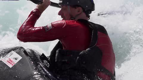 A man battles rapids in a raft