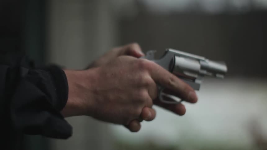 A man fires a handgun