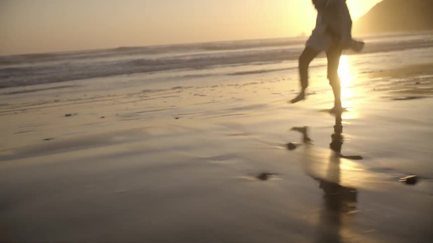A child skips along the beach