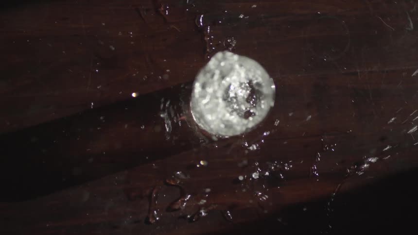Water being shaken and spilled out of a glass