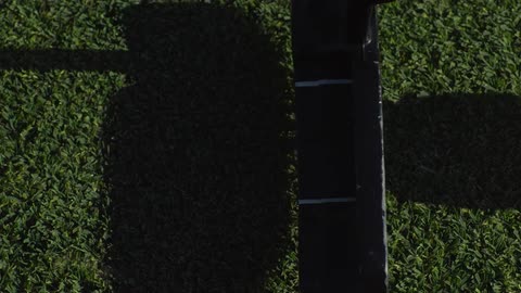 A slow motion close up shot of a golf club hitting a ball