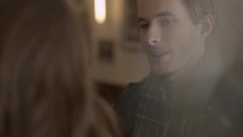 Man smiles at woman in a restaurant