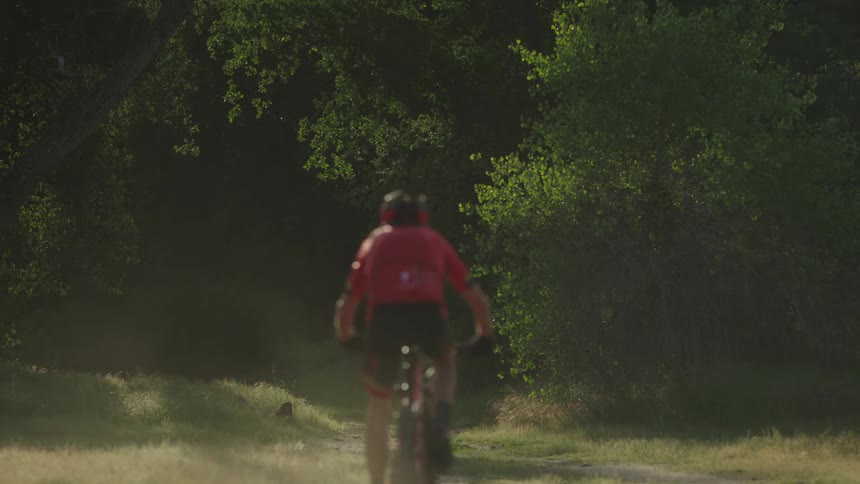 A man rides bike on a trail