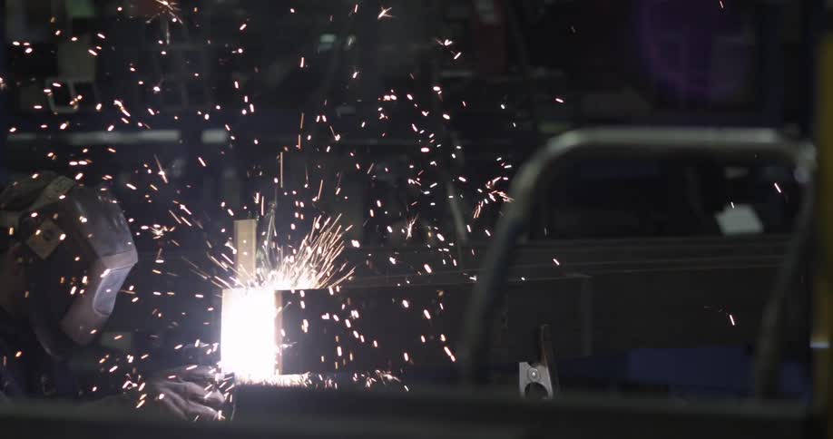 A welder creates sparks while working