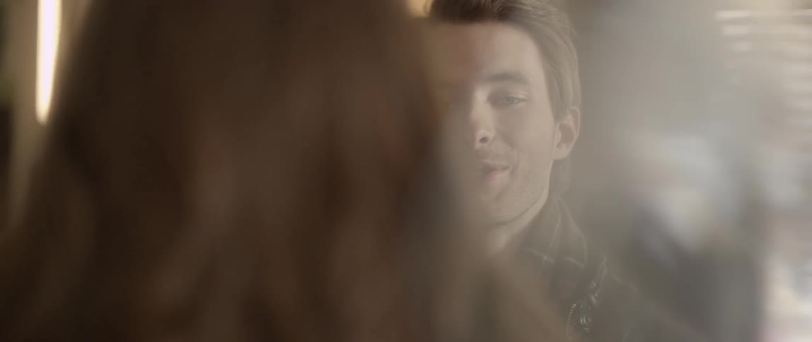 Man takes a drink of wine and kisses a woman