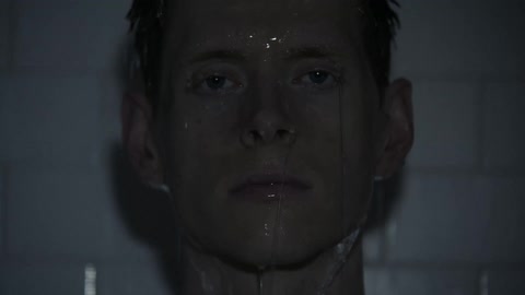 Water pours over a man's head and face