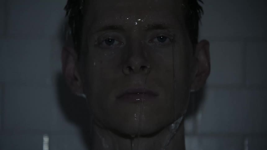 Water pours over a man's head and face