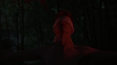 Man wearing a blindfold looks up
