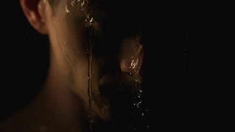 Water pours off a man's face