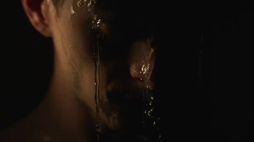 Water pours off a man's face
