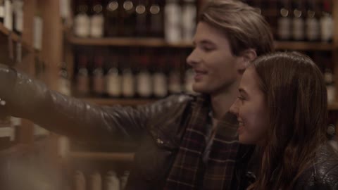 Man and woman choosing wine in a shop