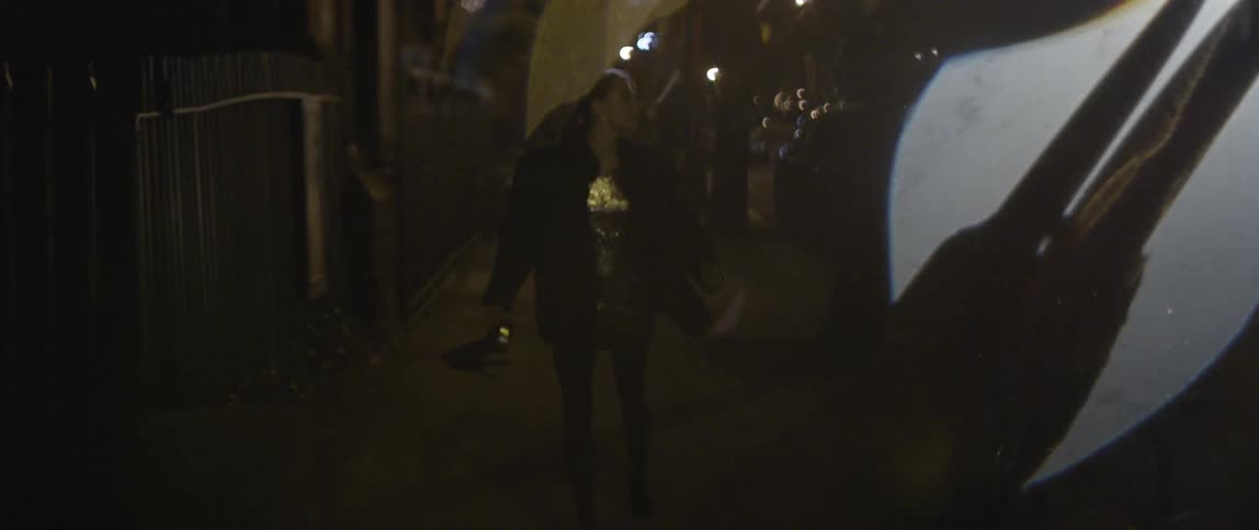A dressed up woman is running, stops, turns back and runs again while looking over her shoulder