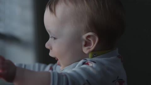 Baby plays with window blinds