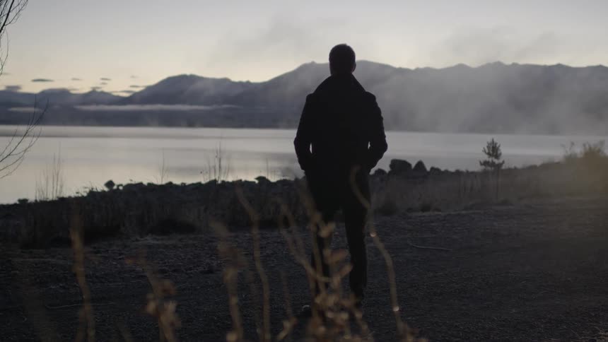 A man looks out over a large body of water