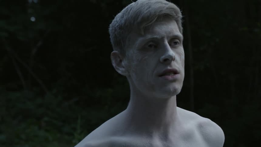 Man covered in white powder is singing