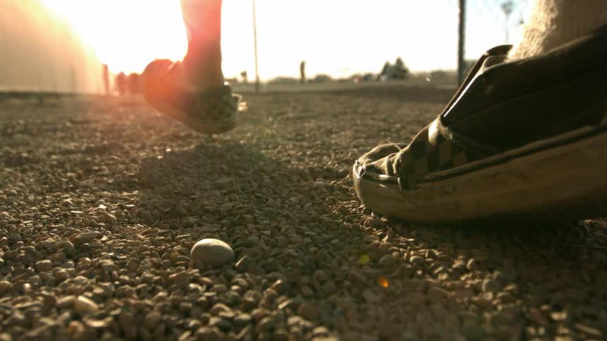 A person walking in gravel
