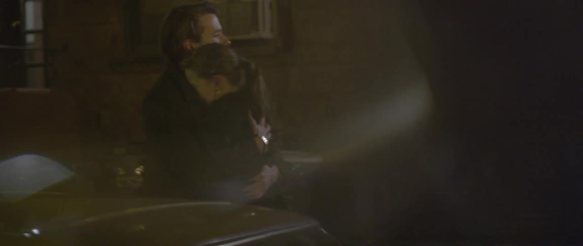 Couple hugging and kissing on a city street