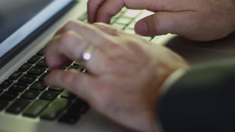 A man types on a keyboard