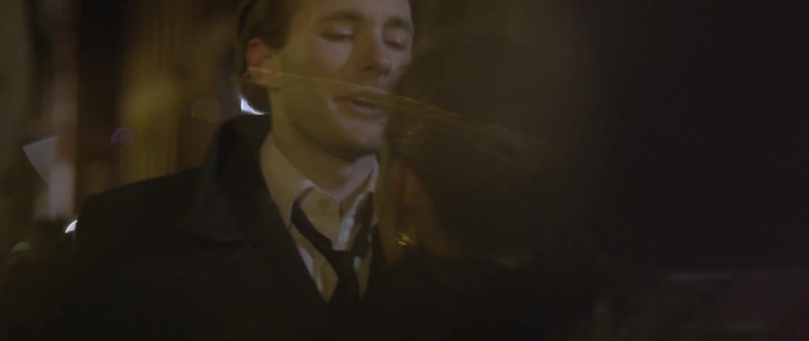 Man hugs woman at night