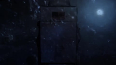 A person in a costume watching projected videos of planets in space