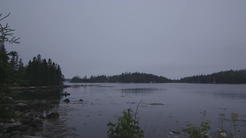 A person canoes on a body of water