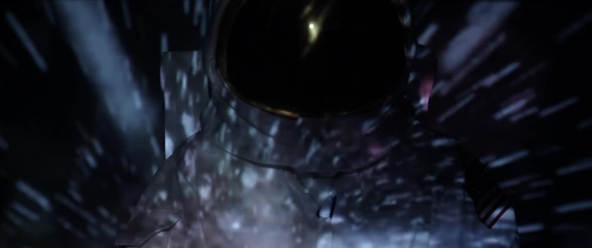 An astronaut with stars projected on him