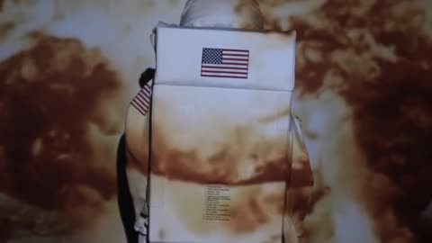 An explosion is projected onto an astronaut