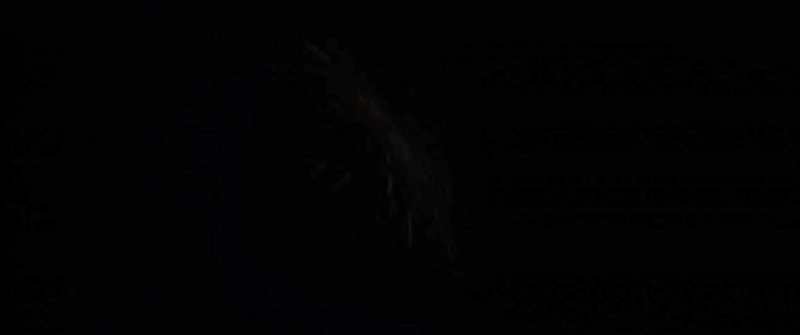 A person in a space helmet watching a video that is reflected on his helmet