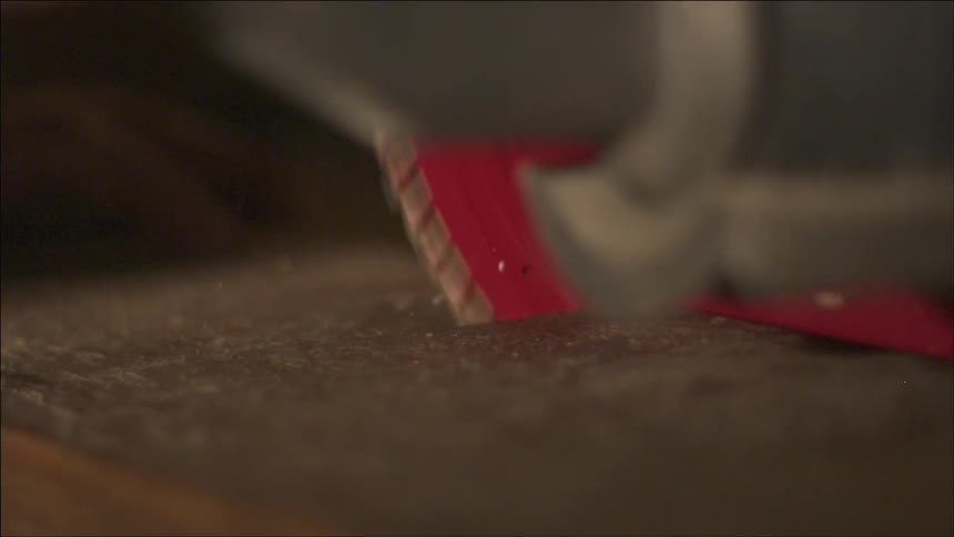 Saw blade cutting through wood in slow motion