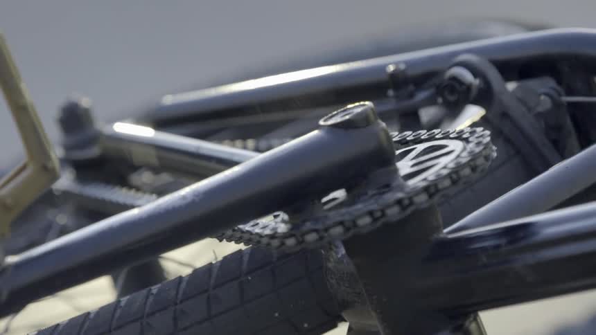 A close up of the pedal chain and wheel of a bicycle