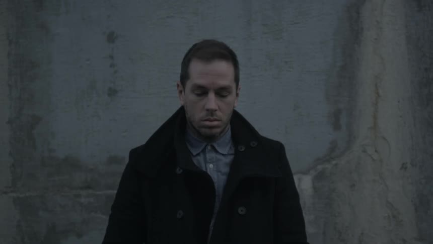 A person standing next to a wall