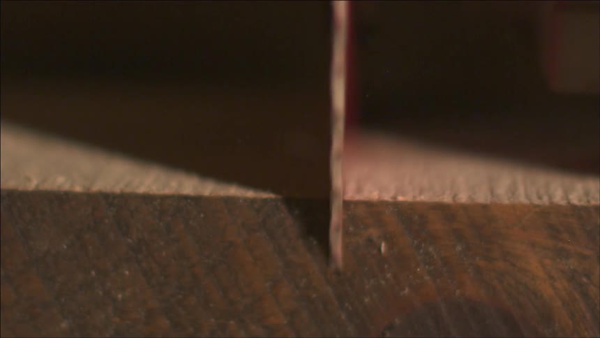 A drill cutting a hole