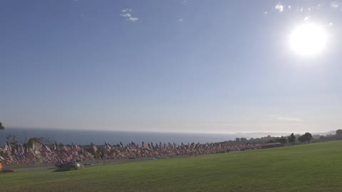 Thousands of american flags wave near water