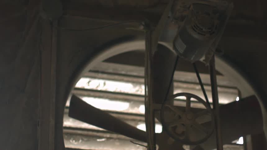 An industrial fan slowly turning