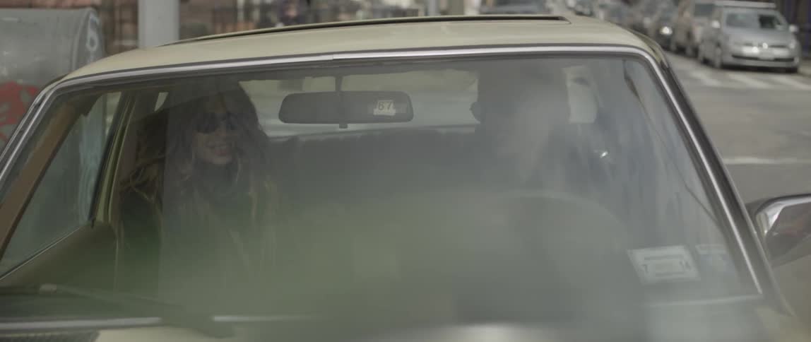 Man and woman driving in car